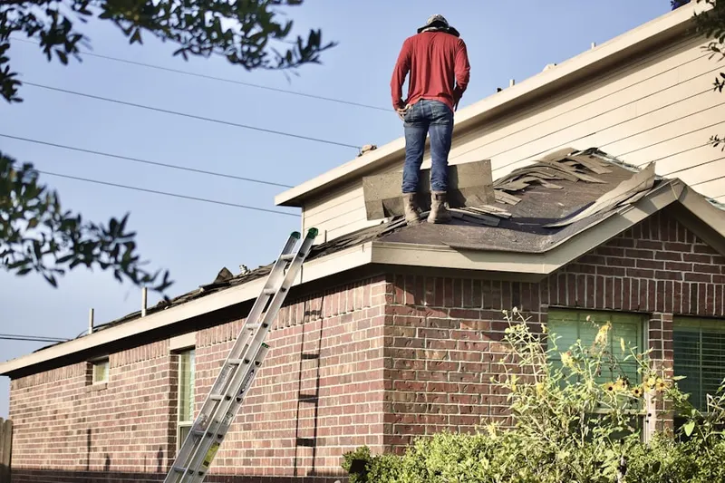Professional roofer working on a residential roof in Dickerson Estates